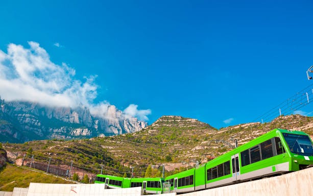 Train ascending Montserrat mountain with scenic view, part of TotMontserrat Card tour from Barcelona.