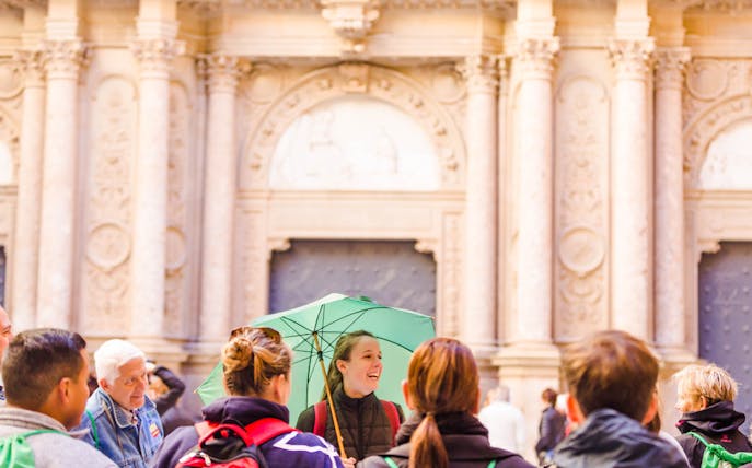 Tour group with guide at Montserrat Sanctuary entrance.