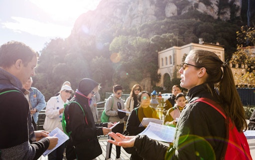 Tour group with audio guides at Montserrat Sanctuary, Spain.