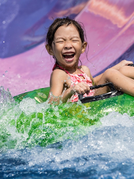Girl on water slide at Wild Wild Wet Singapore.