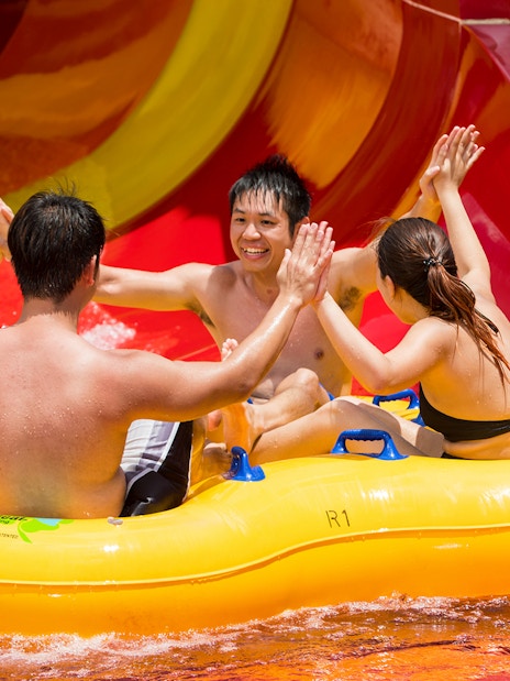Group enjoying a water slide ride at Singapore's Wild Wild Wet.