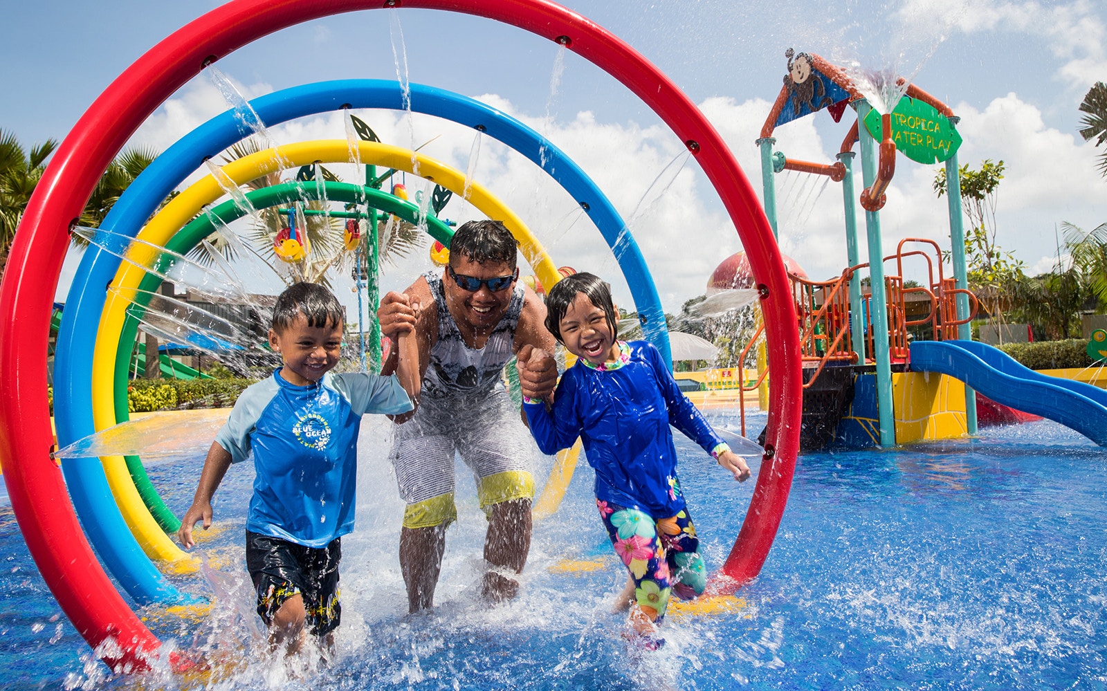Children and adult enjoying water play area at Wild Wild Wet, Singapore, part of Go City Pass.