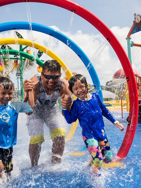 Children and adult enjoying water play area at Wild Wild Wet, Singapore, part of Go City Pass.
