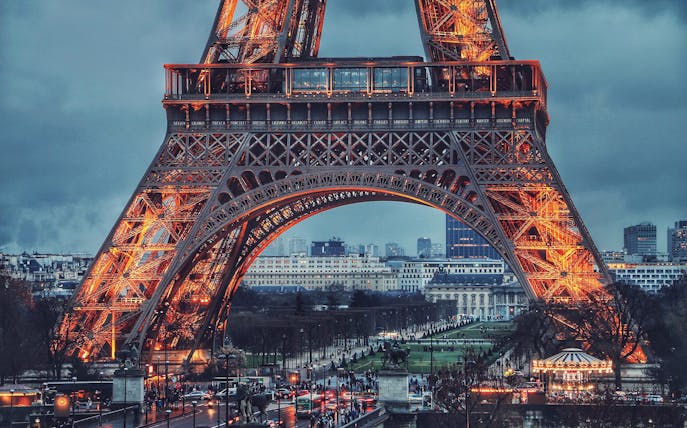 Eiffel Tower illuminated at dusk during a Paris city tour.