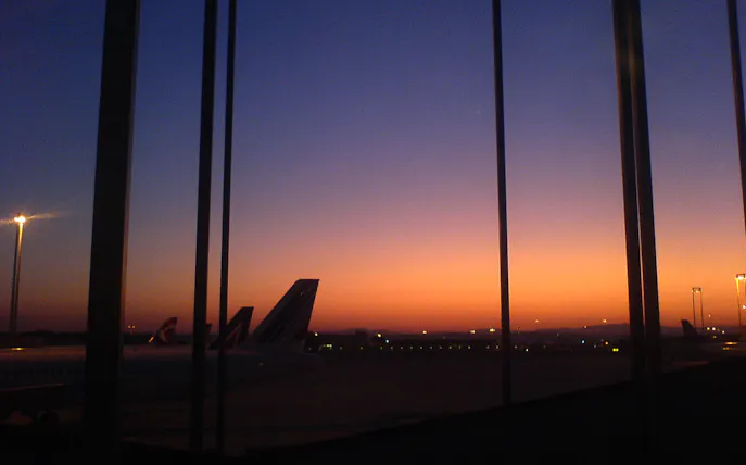 Airplane tails at Fiumicino Airport during sunset, Rome transfer service.
