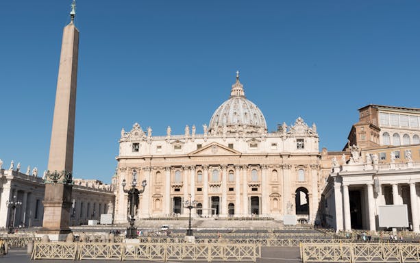 St. Peter's Basilica and obelisk in Vatican City on a sunny day.