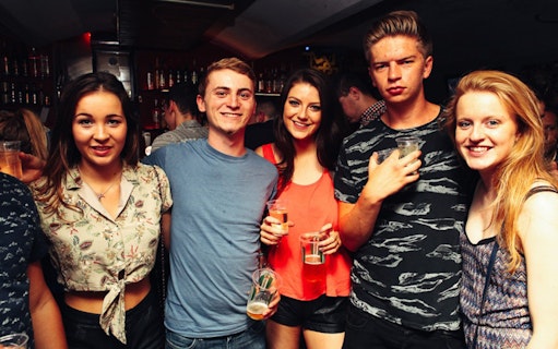 Group enjoying drinks at a lively bar during Prague Pub Crawl.