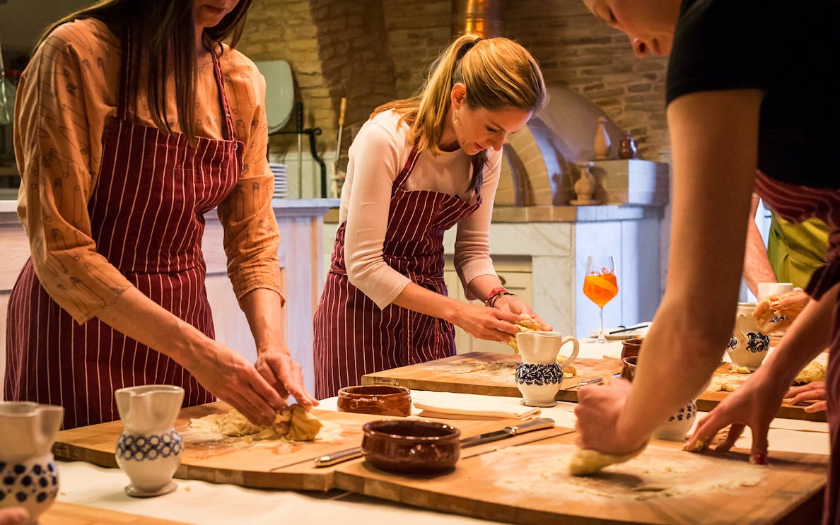 Participants kneading dough during an Italian cooking class in Naples.
