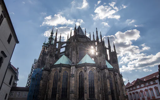 Prague Castle Complex with sun shining through Gothic architecture.