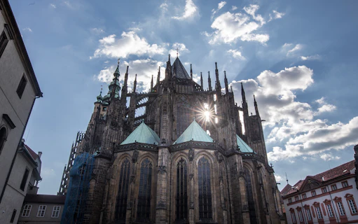 Prague Castle Complex with sun shining through Gothic architecture.