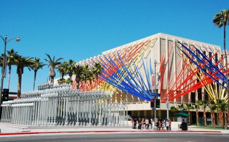 Los Angeles County Museum of Art with colorful installation and urban light display.