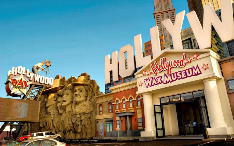 Hollywood Wax Museum entrance with Mount Rushmore-style celebrity sculptures.