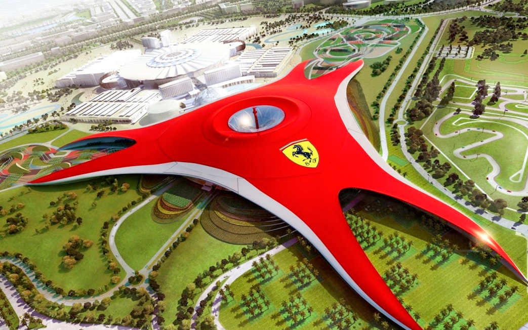 Ferrari World Abu Dhabi aerial view with iconic red roof and surrounding attractions.