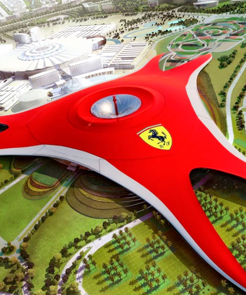Ferrari World Abu Dhabi aerial view with iconic red roof and surrounding attractions.