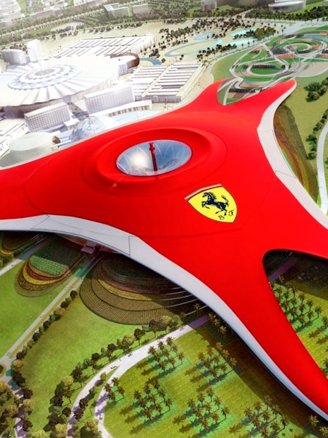 Ferrari World Abu Dhabi aerial view with iconic red roof and surrounding attractions.