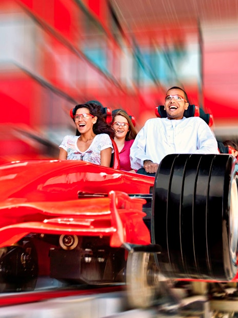 Visitors enjoying a high-speed roller coaster ride at Ferrari World Abu Dhabi.