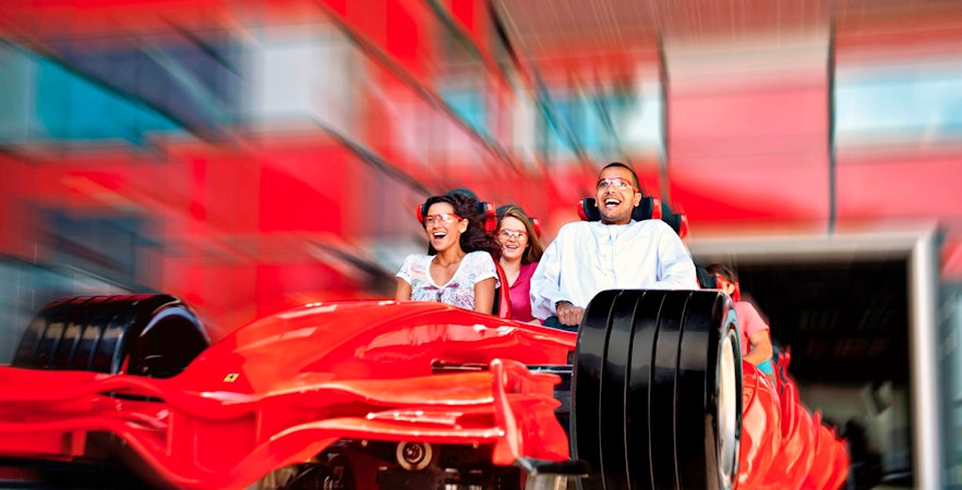 People on a roller coaster at Ferrari World in Dubai