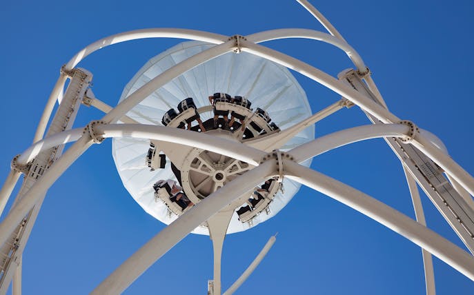 Flying Cup ride structure against blue sky in Dubai.