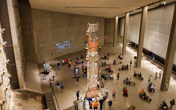 Visitors at the 9/11 Tribute Museum viewing the Last Column memorial.