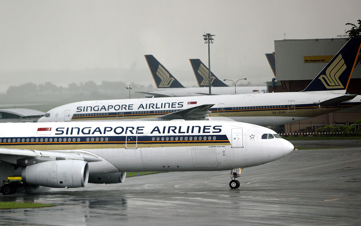 Singapore Airlines planes on tarmac at Singapore Airport for shuttle transfer.