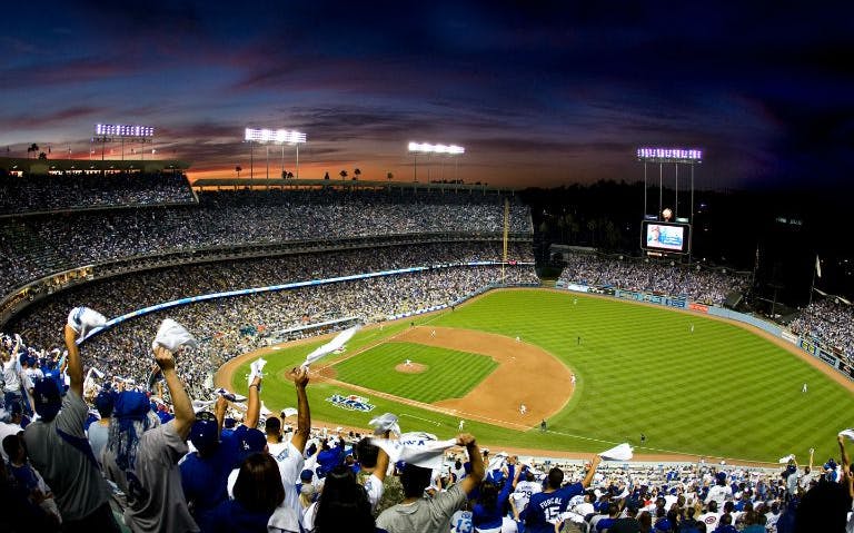 Fans cheering at a baseball game in Dodger Stadium, Los Angeles.