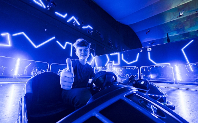 Young person enjoying bumper cars at IMG World Dubai.