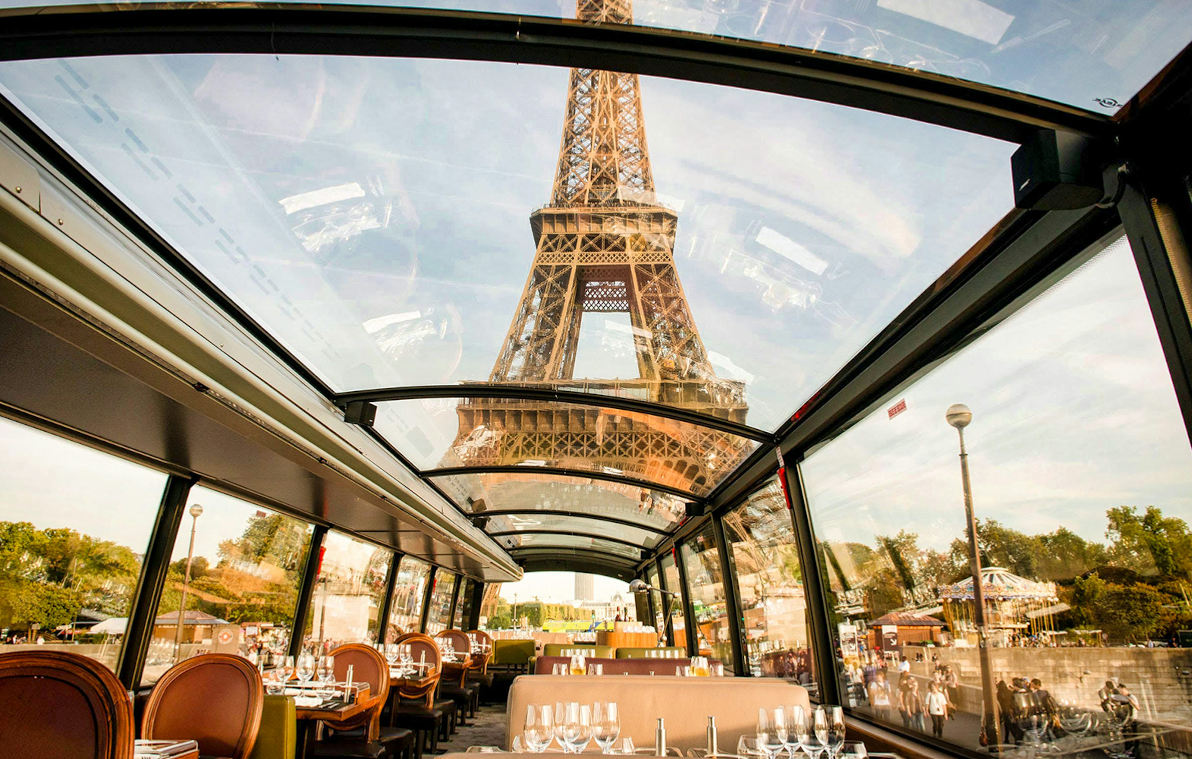 Interior view of La Marina Orsay lunch cruise with Eiffel Tower through glass ceiling, Paris.