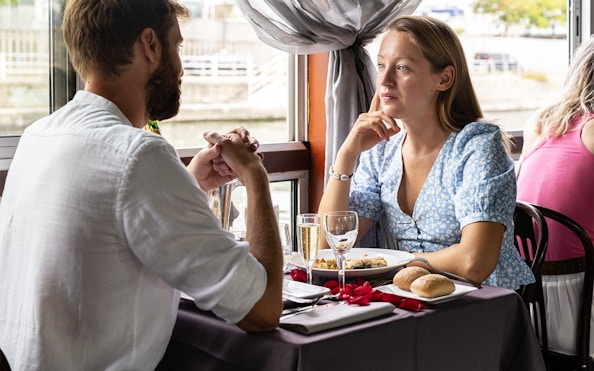 Couple dining on La Marina Orsay Lunch Cruise in Paris.