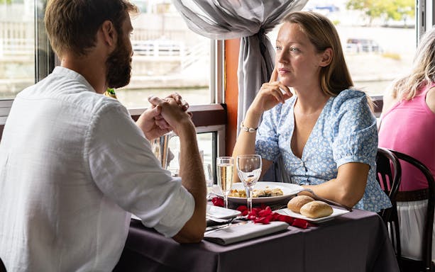 Couple dining on La Marina Orsay Lunch Cruise in Paris.