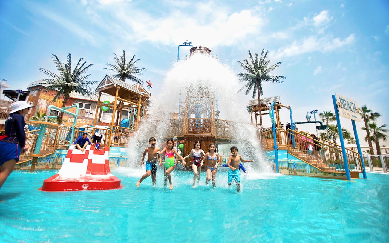 Children playing in the splash zone at Laguna Waterpark, Dubai.