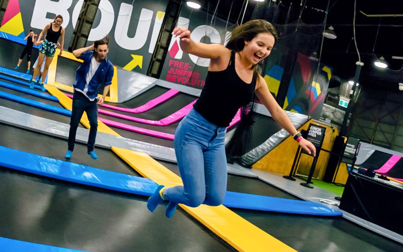 People enjoying trampoline jumping at Bounce Singapore indoor park.