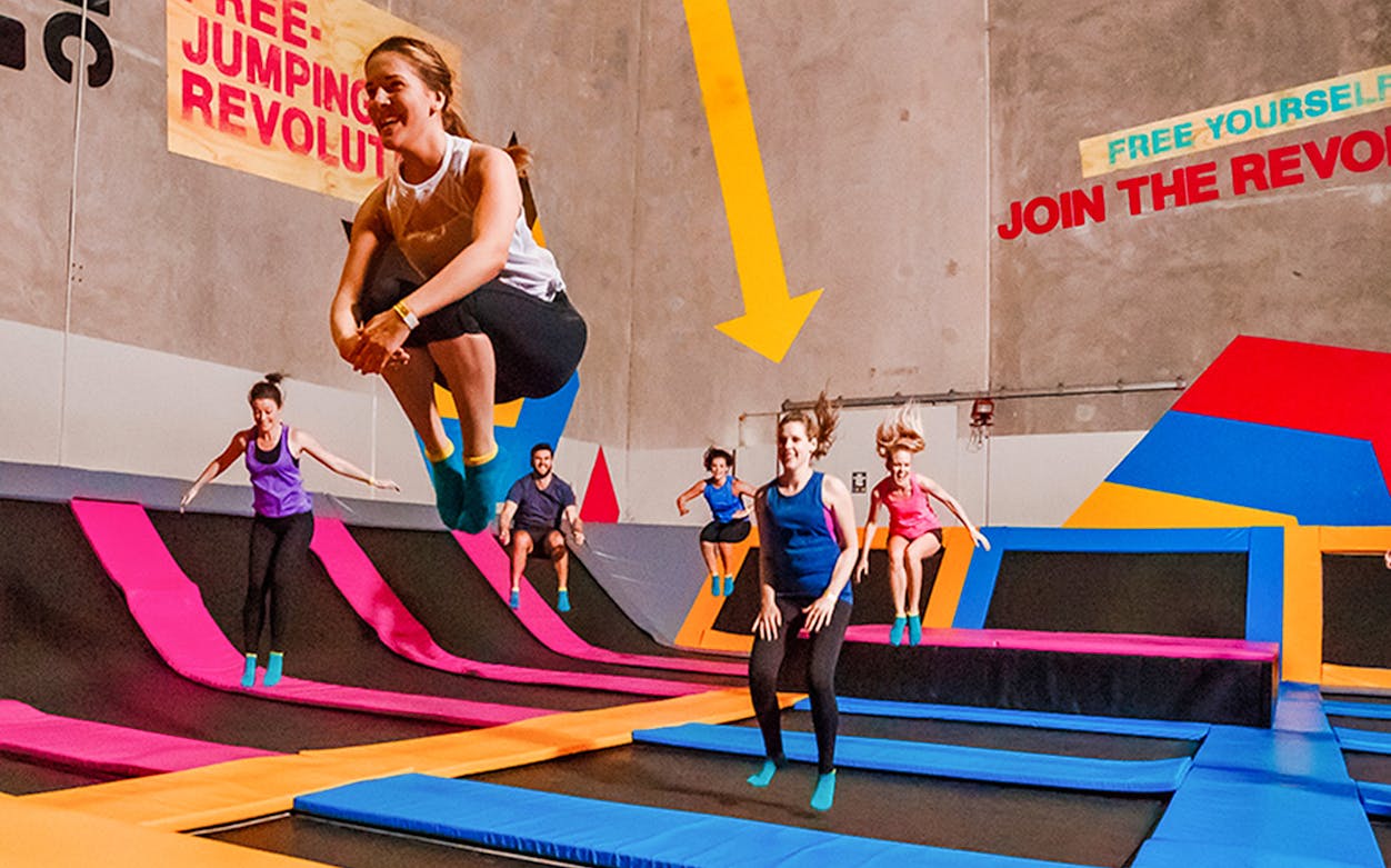 People jumping on trampolines at Bounce Singapore indoor park.