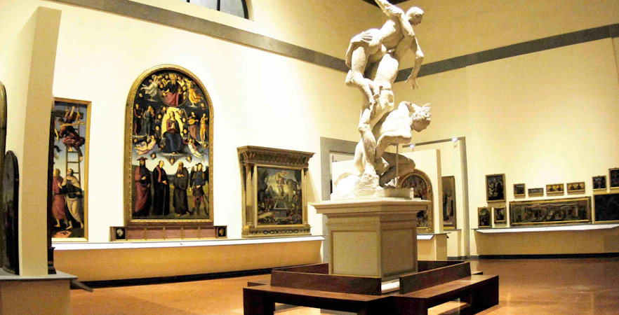 Sculpture and paintings inside Accademia Gallery, Florence, on a guided tour with skip-the-line tickets.