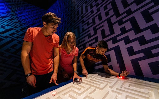 Participants solving a puzzle at Jumble Dubai's urban maze.