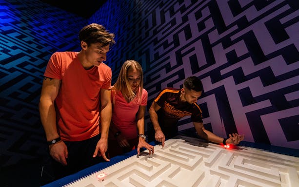 Participants solving a puzzle at Jumble Dubai's urban maze.