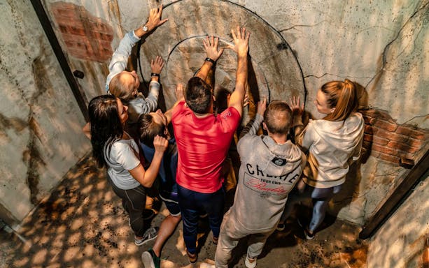 Group solving puzzle in Jumble Dubai's urban maze.