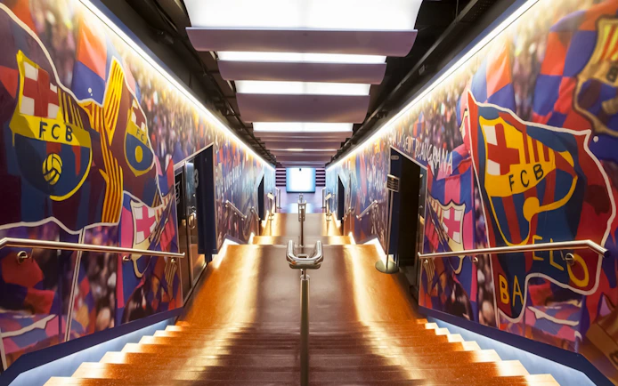 Stadium tunnel with FC Barcelona logos at Camp Nou.