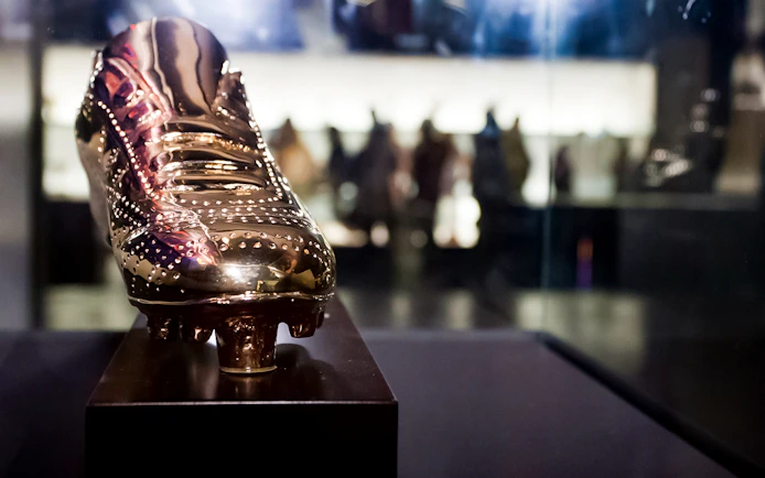 Golden football boot display at FC Barcelona Camp Nou museum.