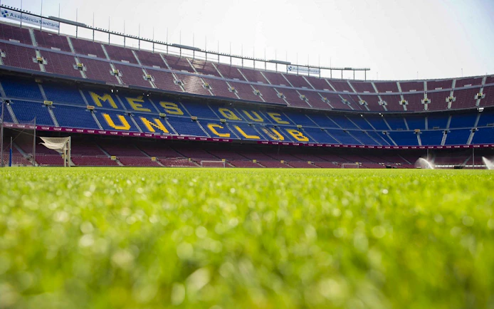 Camp Nou stadium field with "Més Que Un Club" seats, Barcelona.