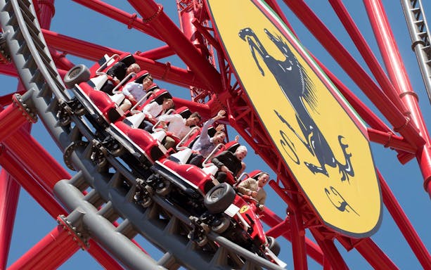 Roller coaster at Ferrari Land, PortAventura World, with excited riders.