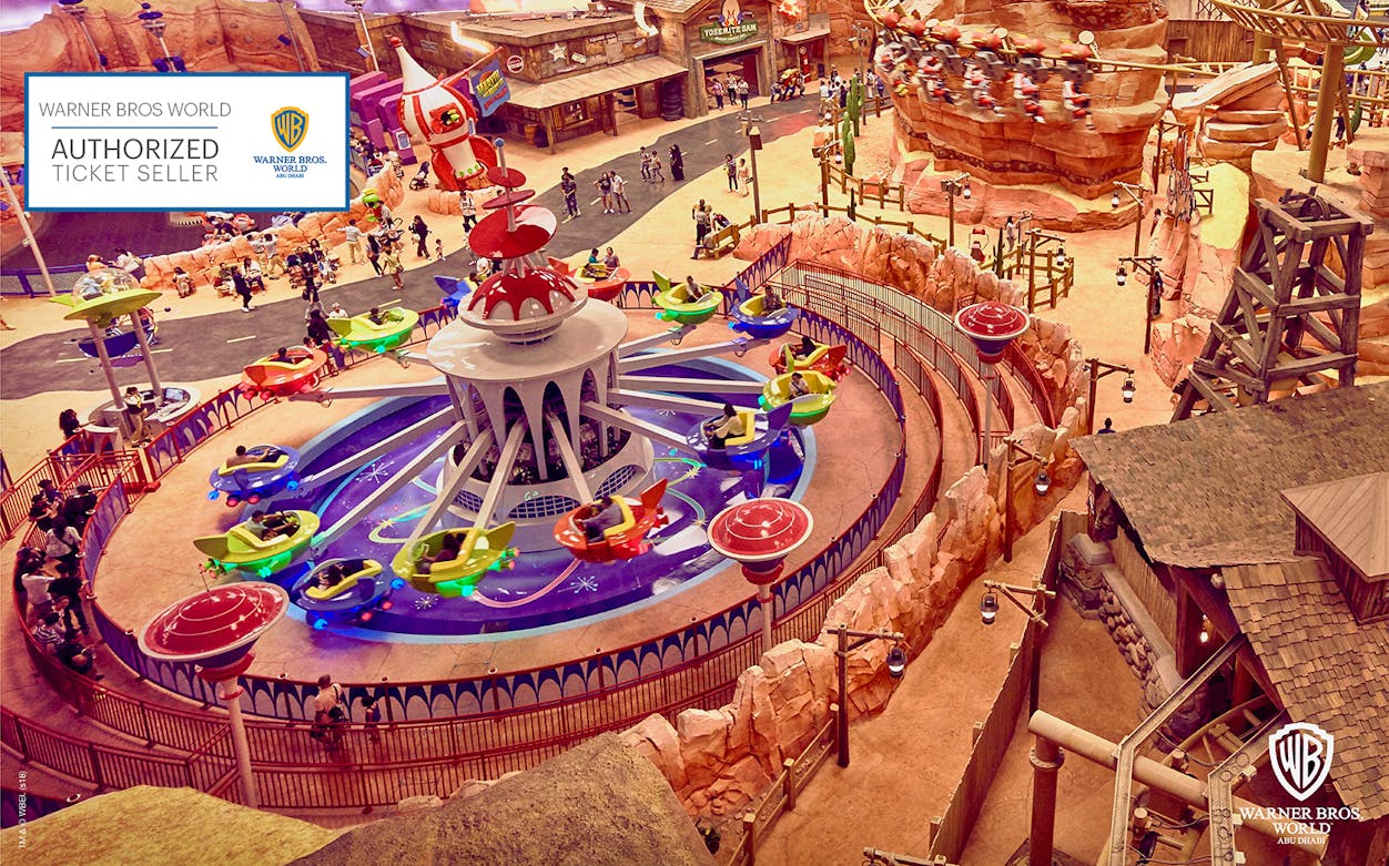 Warner Bros. World Abu Dhabi ride with colorful spinning cars and themed surroundings.