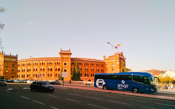 Tour bus in front of Toledo's historic building on 3 Cultures guided day trip.