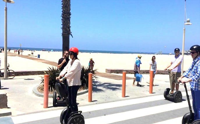 Segway riders on Santa Monica Beach path during Venice Beach tour.