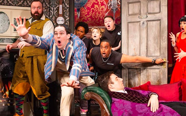 Cast members of "The Play That Goes Wrong" in a chaotic scene on Broadway.