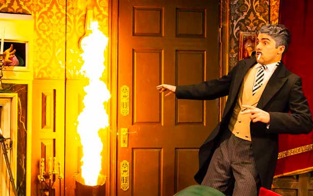 Actor reacting to a fire on stage during "The Play That Goes Wrong" on Broadway.
