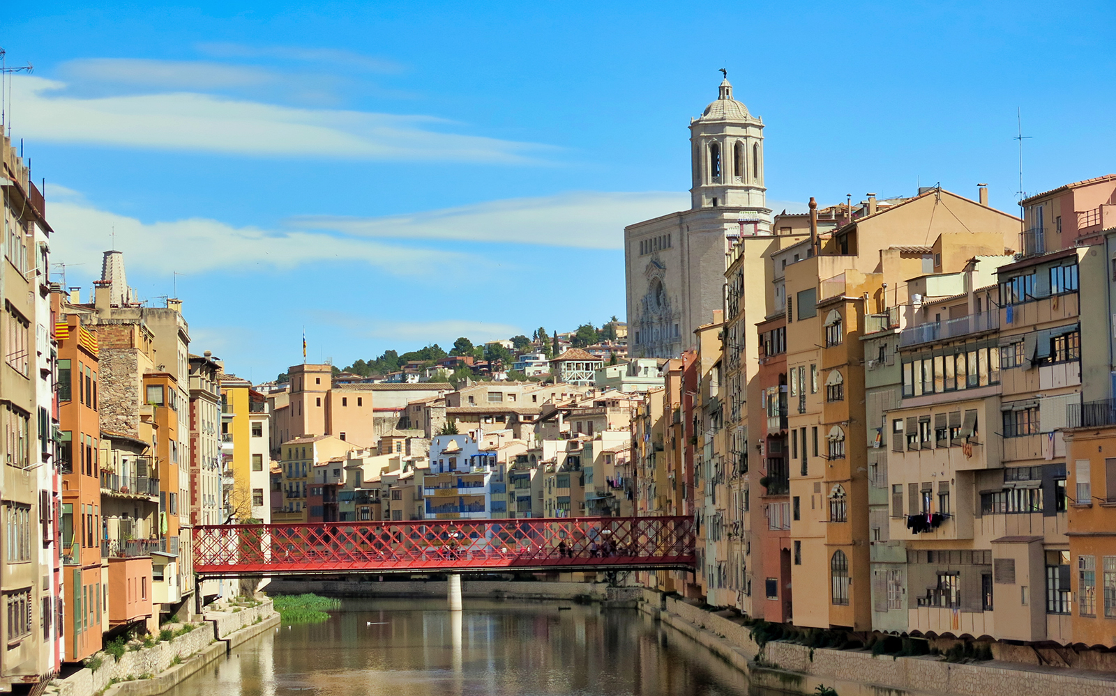 Colorful buildings along the Onyar River with Girona Cathedral in the background, Girona.