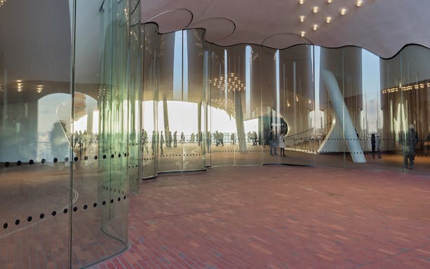 Elbphilharmonie glass facade with reflections, Hamburg harbor tour.