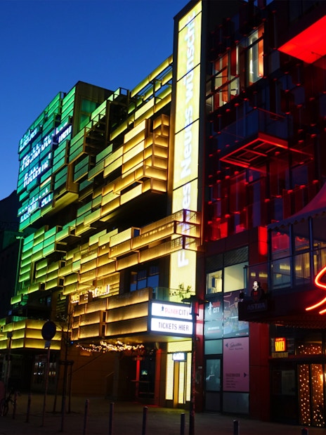 Colorful neon lights on buildings in Hamburg's Reeperbahn district at night.