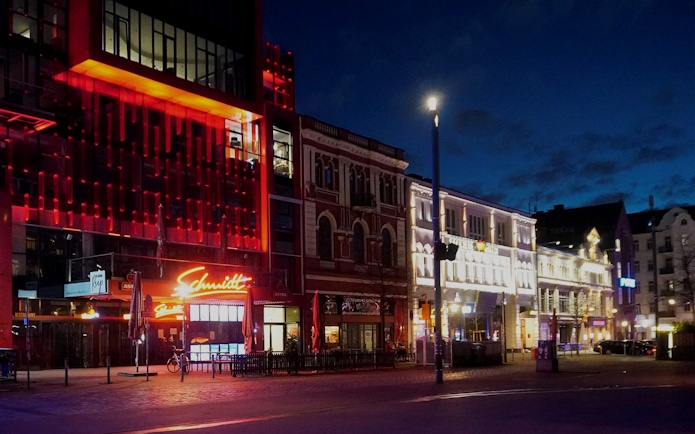 Reeperbahn nightlife scene in Hamburg with illuminated buildings and neon signs.