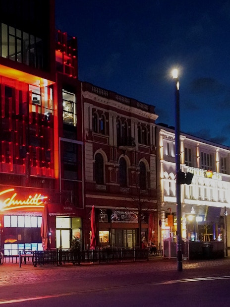 Reeperbahn nightlife scene in Hamburg with illuminated buildings and neon signs.